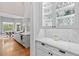 Open-concept kitchen with an island, marble countertops, and a breakfast nook with backyard views at 1440 Water View Ln, Suwanee, GA 30024