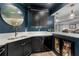 Kitchen featuring stainless steel appliances, modern dark cabinets and sleek countertops at 1440 Water View Ln, Suwanee, GA 30024