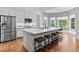 Modern kitchen with white cabinets, quartz countertops, and stainless steel appliances at 1440 Water View Ln, Suwanee, GA 30024