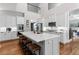 Spacious kitchen featuring a large island, marble countertops, stainless steel appliances, and hardwood floors at 1440 Water View Ln, Suwanee, GA 30024