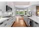 Modern kitchen featuring an island, marble countertops, and a breakfast nook overlooking a green yard at 1440 Water View Ln, Suwanee, GA 30024