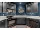 A kitchen featuring black appliances, granite countertops and updated fixtures at 1440 Water View Ln, Suwanee, GA 30024