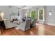 Cozy living room featuring a fireplace, hardwood floors, and plenty of natural light at 1440 Water View Ln, Suwanee, GA 30024