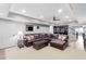 A large living room with carpet and hard surface flooring and a huge leather couch at 1440 Water View Ln, Suwanee, GA 30024
