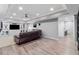 Spacious living room featuring recessed lighting, built-in shelving, and durable floors at 1440 Water View Ln, Suwanee, GA 30024