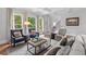 Inviting living room featuring hardwood floors, coffered ceilings, and a large arched floor lamp at 1440 Water View Ln, Suwanee, GA 30024