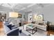 Bright and open living room with hardwood floors, coffered ceilings, and neutral color palette at 1440 Water View Ln, Suwanee, GA 30024