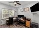 This office boasts dual monitors, a large window, and a ceiling fan at 1440 Water View Ln, Suwanee, GA 30024