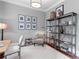 Well-appointed home office featuring stylish decor, ample lighting and bookshelf storage at 1440 Water View Ln, Suwanee, GA 30024