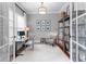 Bright home office featuring large windows, white trim, desk space, and custom shelving at 1440 Water View Ln, Suwanee, GA 30024