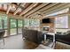 Cozy screened-in porch with a stone fireplace, TV, and wood ceiling at 1440 Water View Ln, Suwanee, GA 30024