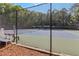 The community tennis court is fenced and has lighting for evening play at 1440 Water View Ln, Suwanee, GA 30024