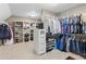 Organized walk-in closet with ample storage, including shelves and rods for clothing and accessories at 1440 Water View Ln, Suwanee, GA 30024