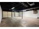Unfinished basement featuring a black painted ceiling, cement floors and a garage door at 1627 Rex Dr, Marietta, GA 30066
