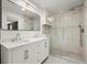 Modern bathroom featuring double sink vanity, large mirror and tiled glass shower at 1627 Rex Dr, Marietta, GA 30066