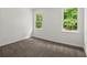 Bright bedroom featuring neutral walls, carpet, and two windows providing natural light at 1627 Rex Dr, Marietta, GA 30066