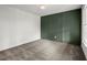 Cozy bedroom with gray carpet, accented wall, and stylish light fixture at 1627 Rex Dr, Marietta, GA 30066