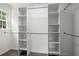 Walk-in closet with custom shelves and hanging racks and carpeted floors at 1627 Rex Dr, Marietta, GA 30066