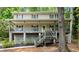 Inviting two-story house featuring a spacious covered porch and a serene wooded setting at 1627 Rex Dr, Marietta, GA 30066