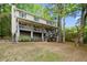 Two-story home with a large, covered porch, exterior stairs and mature trees at 1627 Rex Dr, Marietta, GA 30066