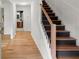 Bright hallway showcasing wood floors and staircase with modern black rails at 1627 Rex Dr, Marietta, GA 30066