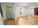 Bright living room featuring hardwood floors, white walls, and a stone fireplace, filled with natural light from windows at 1627 Rex Dr, Marietta, GA 30066