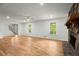 Spacious living room with hardwood floors, white walls, stone fireplace, and natural light, perfect for entertaining at 1627 Rex Dr, Marietta, GA 30066