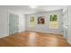 Bright living room with hardwood floors, two windows, painted art and light blue doors at 1627 Rex Dr, Marietta, GA 30066