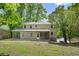 Beautiful home featuring an expansive lawn, rear porch, and mature trees at 1627 Rex Dr, Marietta, GA 30066