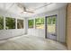 Sunroom with large windows, tile floors, a ceiling fan, and outdoor access to backyard at 1627 Rex Dr, Marietta, GA 30066
