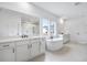 Bright bathroom featuring double vanity, soaking tub, and glass enclosed shower at 2505 Kirkwood Dr, Cumming, GA 30041