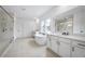Bright bathroom featuring double vanity, soaking tub, and glass enclosed shower at 2505 Kirkwood Dr, Cumming, GA 30041