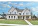 Stunning white two-story home with manicured lawn and inviting front porch at 2505 Kirkwood Dr, Cumming, GA 30041
