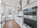 Modern kitchen with stainless steel appliances, double ovens, and white cabinets at 2505 Kirkwood Dr, Cumming, GA 30041