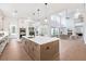 A bright, open kitchen with a large island, stainless steel appliances, and hardwood floors connects to the living room at 2505 Kirkwood Dr, Cumming, GA 30041