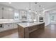 Open kitchen with a large island, stainless steel appliances, and bright cabinets at 2505 Kirkwood Dr, Cumming, GA 30041