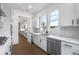 Galley kitchen featuring white cabinets, stainless appliances and a view to the yard at 2505 Kirkwood Dr, Cumming, GA 30041