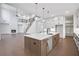 Spacious open-concept kitchen features a large island with stainless steel appliances and white cabinets at 2505 Kirkwood Dr, Cumming, GA 30041