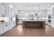 Bright kitchen featuring white cabinets, an island with seating, stainless steel appliances, and modern lighting fixtures at 2505 Kirkwood Dr, Cumming, GA 30041