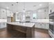 Bright kitchen featuring a large island, modern pendant lighting, and stainless steel appliances at 2505 Kirkwood Dr, Cumming, GA 30041