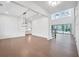 Open room with hardwood floors, high ceilings, large windows, and a glimpse of the kitchen at 2505 Kirkwood Dr, Cumming, GA 30041