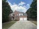 Charming two-story brick home features a two-car garage and a well-manicured front lawn at 300 Bermuda Ct, Dallas, GA 30157