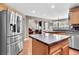 Open-concept kitchen with stainless steel appliances, center island, and hardwood floors at 300 Bermuda Ct, Dallas, GA 30157