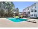 Backyard with a large in-ground pool, diving board, patio furniture, and a covered deck at 300 Bermuda Ct, Dallas, GA 30157