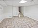 A spacious basement area has tile flooring and stairs leading to other parts of the house at 527 Tomahawk Trl, Woodstock, GA 30188