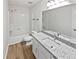 Clean bathroom featuring a vanity with a granite countertop, modern fixtures, and a shower at 527 Tomahawk Trl, Woodstock, GA 30188