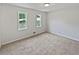 Bright bedroom featuring two windows, fresh paint and carpet at 527 Tomahawk Trl, Woodstock, GA 30188