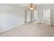 Spacious bedroom featuring carpet, and three doors at 527 Tomahawk Trl, Woodstock, GA 30188