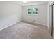 Cozy bedroom with neutral carpet, ample natural light, and spacious closet at 527 Tomahawk Trl, Woodstock, GA 30188