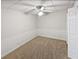 A cozy bedroom features neutral carpet, a ceiling fan, wainscoting, and a closet for ample storage at 527 Tomahawk Trl, Woodstock, GA 30188